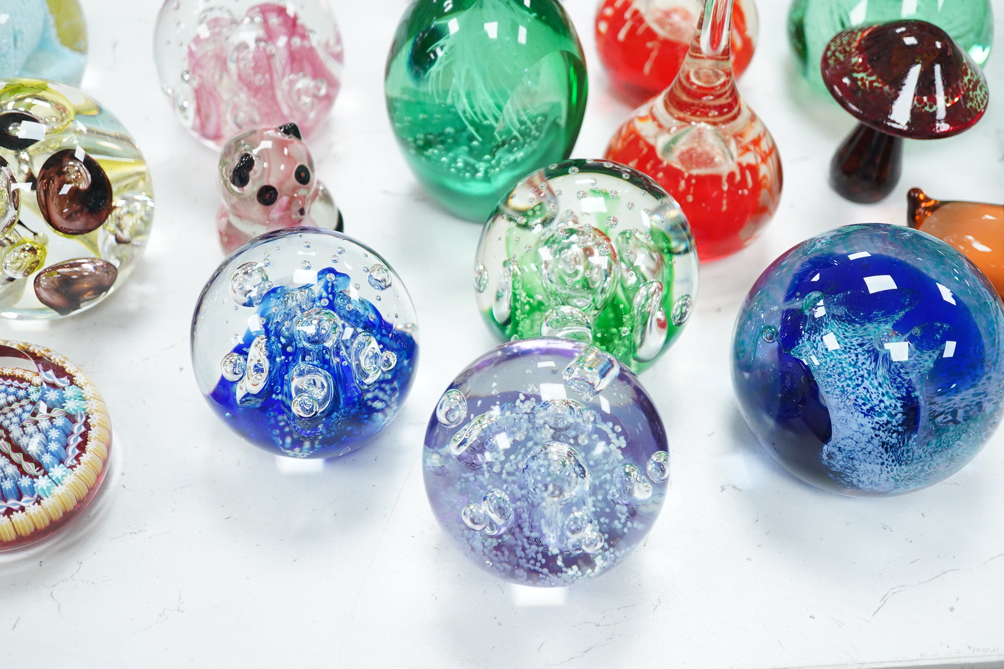 A group of glass paperweights to include Caithness and Perthshire, largest 14cm high. Condition - good